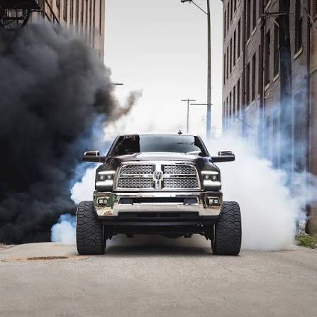 Lifted Ram truck photographed from the front in a city street